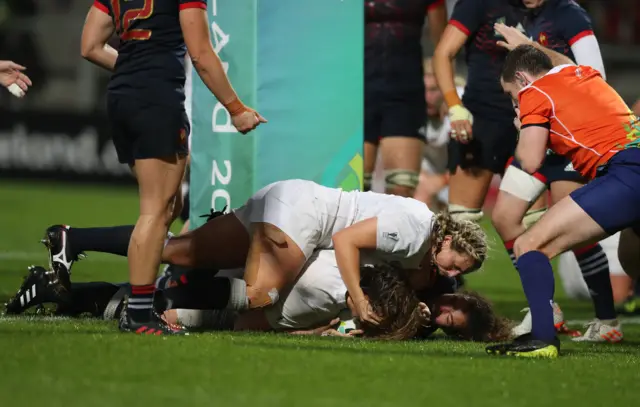 Sarah Bern of England crashes over the line to score