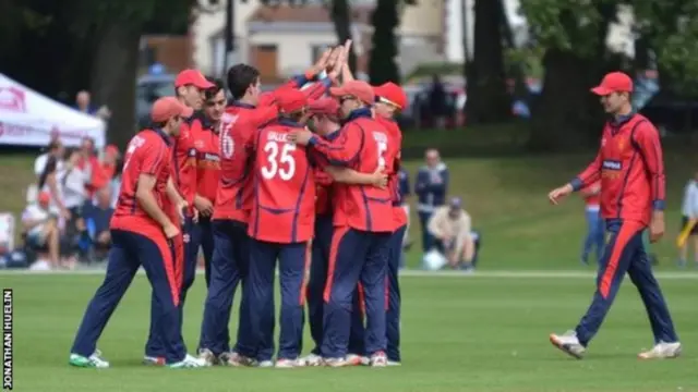 Jersey cricket players celebrate a wicket