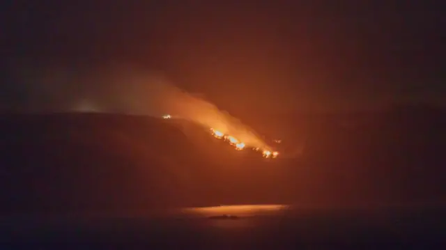 Sark west coast fire, viewed from Guernsey