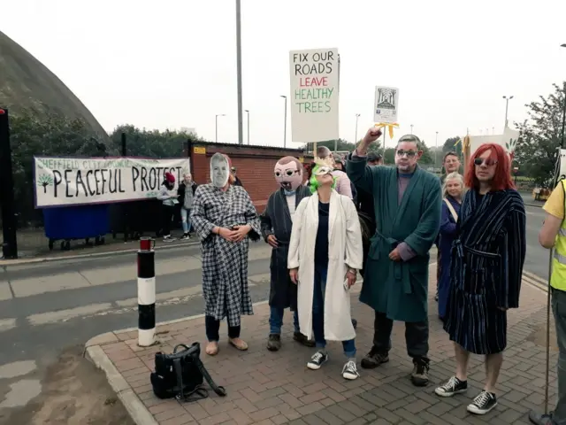 Protesters with banner outside Olive Grove depot