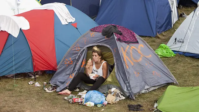 Festival goer eats in her tent at Polish music festival