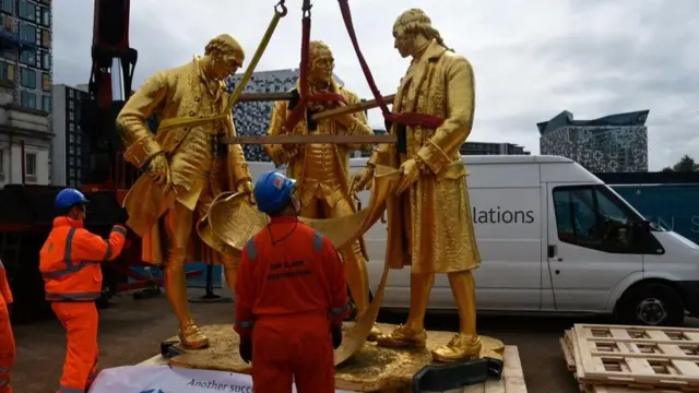 The bronze statue of Matthew Boulton, James Watt and William Murdoch being moved in Birmingham