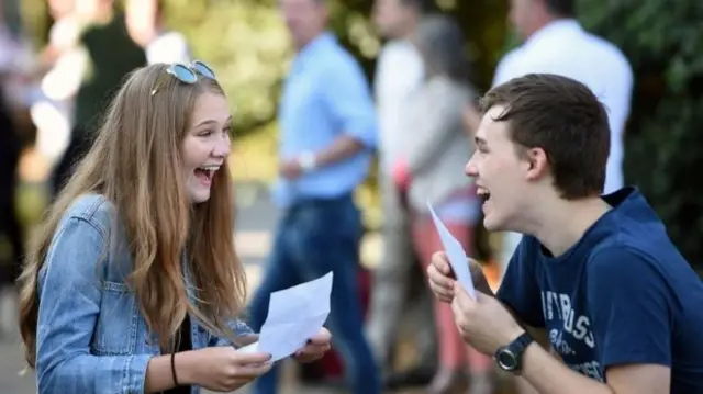 Two pupils getting their GCSE results