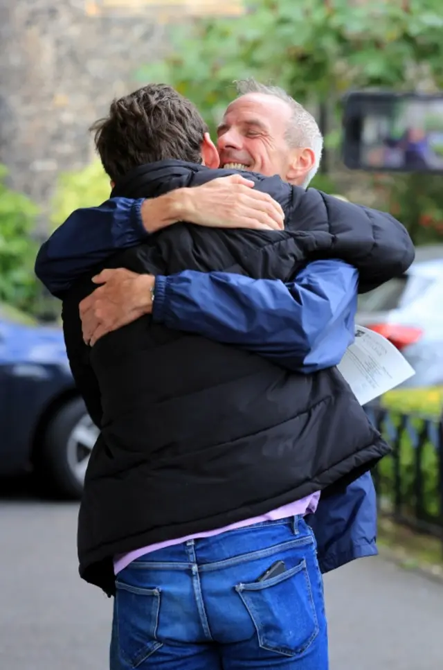 Woody Cook being hugged by his father Norman Cook