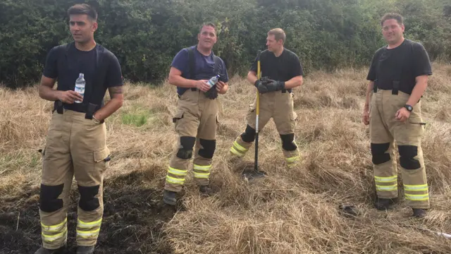 Firemen in a field