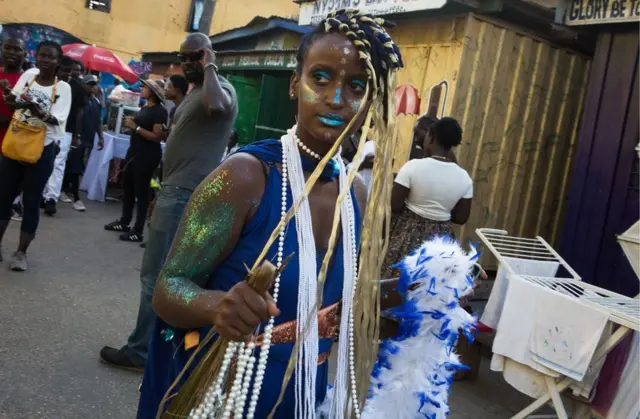 A picture taken on August 19, 2017 shows a woman wearing a decorative attire during the annual Chale Wote Street Art Festival at James town in Accra.