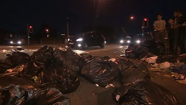 Rubbish bags strewn across the road in Birmingham