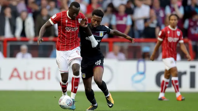 Famara Diedhiou of Bristol City and Joshua Onomah of Aston Villa in action