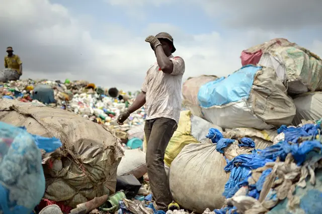 Man surrounded by plastic bags