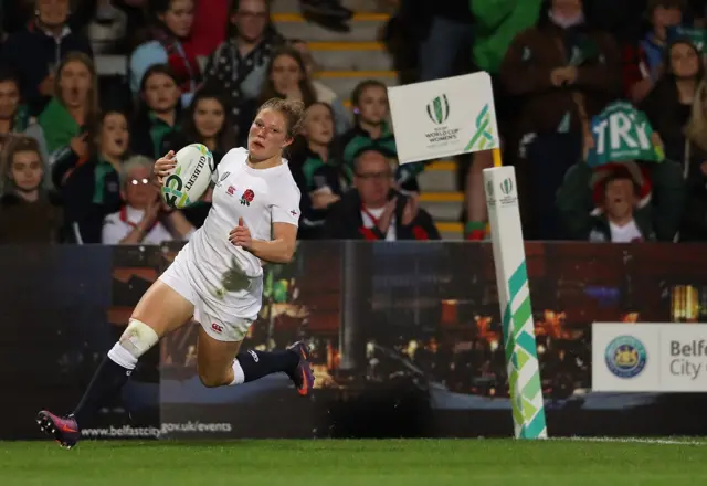 Lydia Thompson runs in a try for England