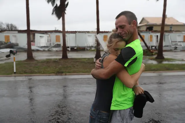 Jessica Campbell hugs Jonathan Fitzgerald (L-R) after riding out Hurricane Harvey in an apartment on August 26, 2017 in Rockport, Texas