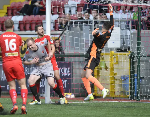 Jordan Owens hooks the ball into the Cliftonville net