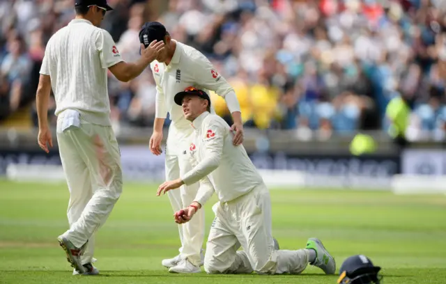 Joe Root is congratulated by his team mates