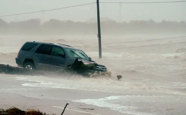 A car is surrounded by floodwaters from Hurricane Harvey in Point Comfort, Texas, August 26, 2017.