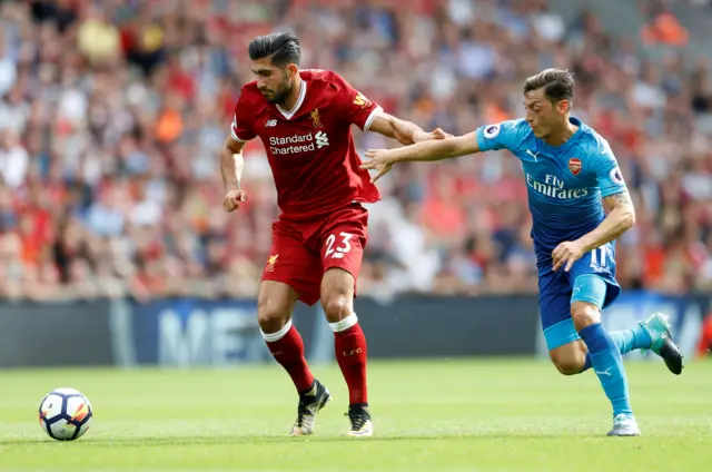 Liverpool's Emre Can in action with Arsenal's Mesut Ozil