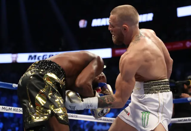 McGregor throws a punch at Mayweather