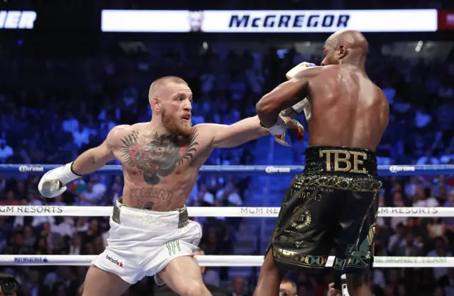 Conor McGregor punches Floyd Mayweather Jr.