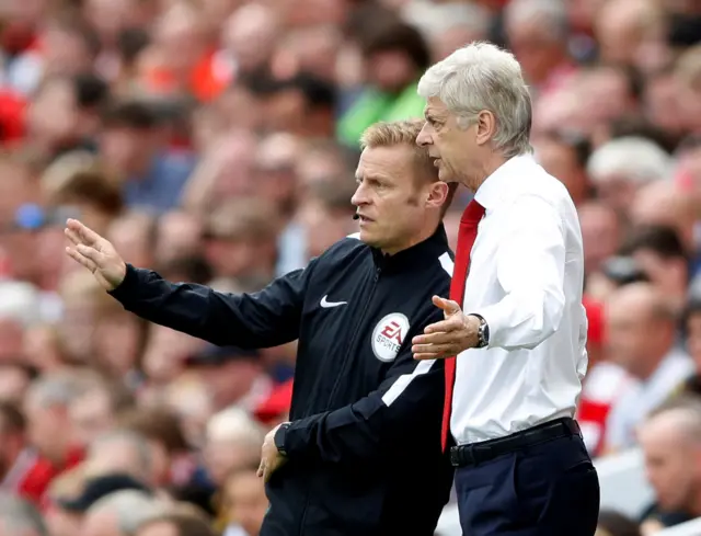 Arsene Wenger speaks to fourth official Mike Jones