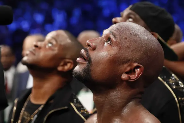 Floyd Mayweather looks up after winning