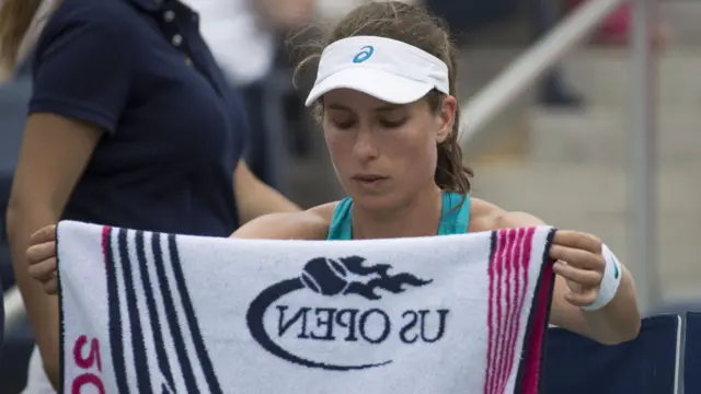 Johanna Konta of Great Britain rests between games