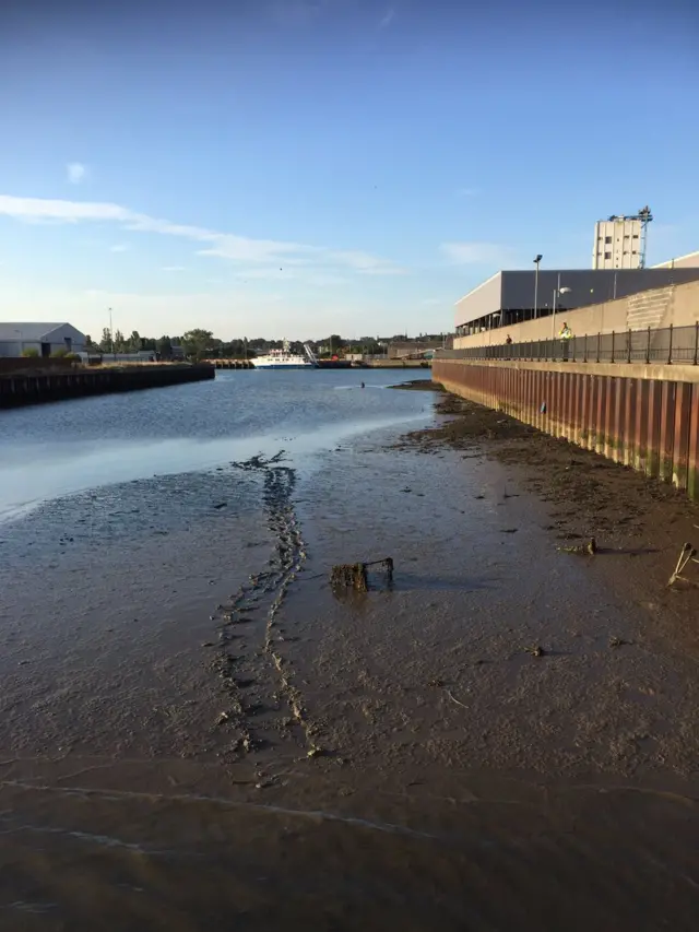 Emergency services rescue a man from mud at Lowestoft harbour