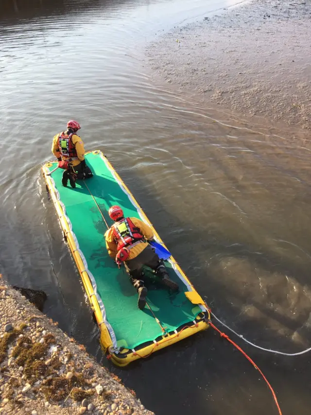 Emergency services rescue a man from mud at Lowestoft harbour