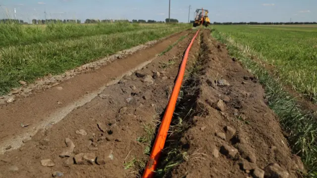 Laying cable in a field