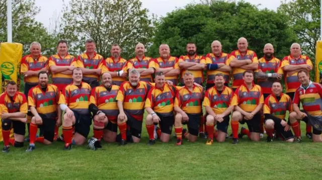 Mark Collin pictured with his team, fourth from the left on the back row