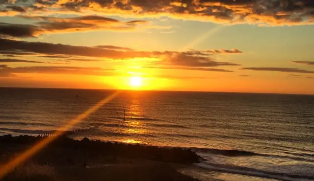 The sun coming up over the sea at Hornsea.