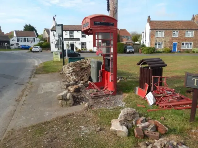 The damaged village phone box.