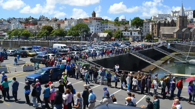 Cruise passengers lining up on Guernsey's Albert Pier to get tenders back to their ship