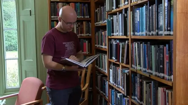 Ryan MacDonald reading a book.