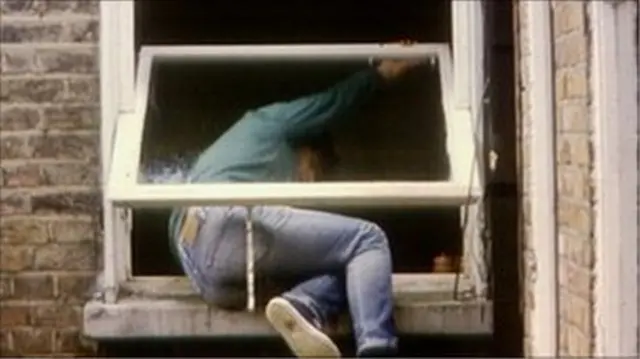 Generic man climbing through a window