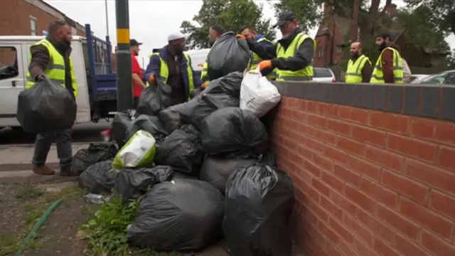 Men emptying bin bags