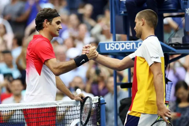 Roger Federer of Switzerland shakes hands after defeating Mikhail Youzhny of Russia