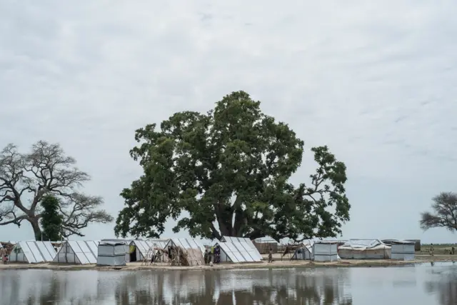 This file photo taken on July 29, 2017 shows Internally-Displaced Peoples tents standing next to a pool of water created by heavy rains the night before in Rann in north-east of Nigeria close to the Cameroonian border.