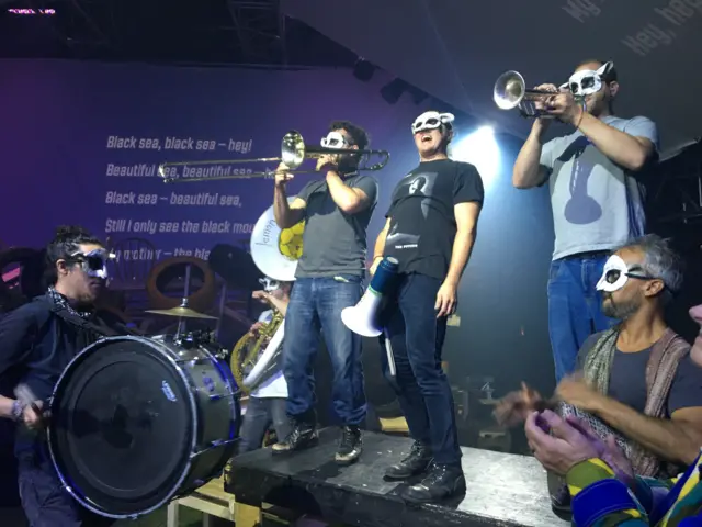 A Ukrainian band playing trombone, trumpet and drums