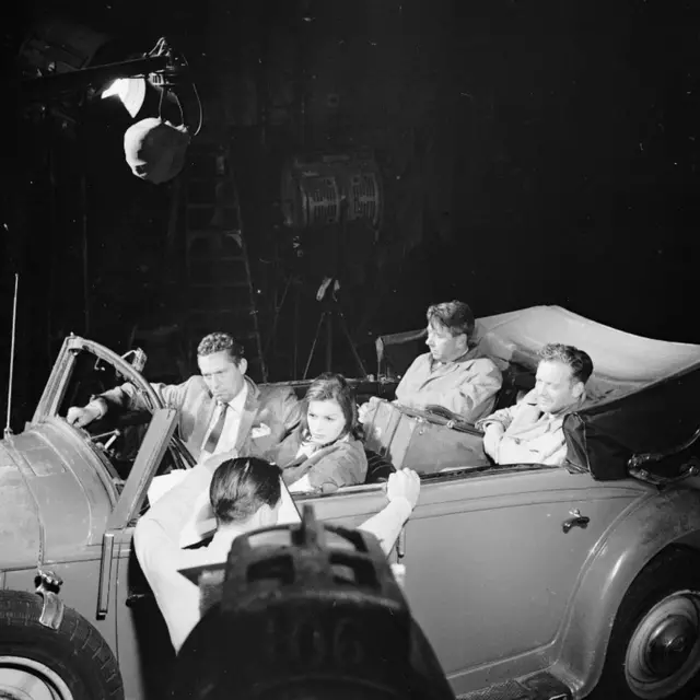 Actors Eva Bartok, Peter Finch, Tony Britton and Alexander Knox are pictured in an old Mercedes at Pinewood Studios