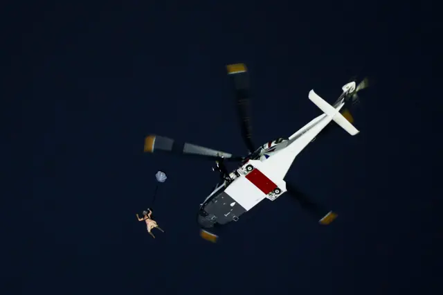 'James Bond' parachutes out of a helicopter