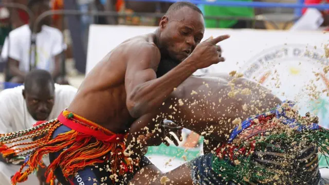 Debe Blaise of Burkina Faso (right) takes on Niger's Garba Mourtala in the men's wrestling 66kg quarter-final on Thursday 28 July.