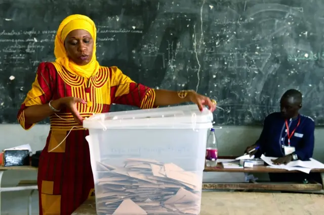 Woman closing ballot box