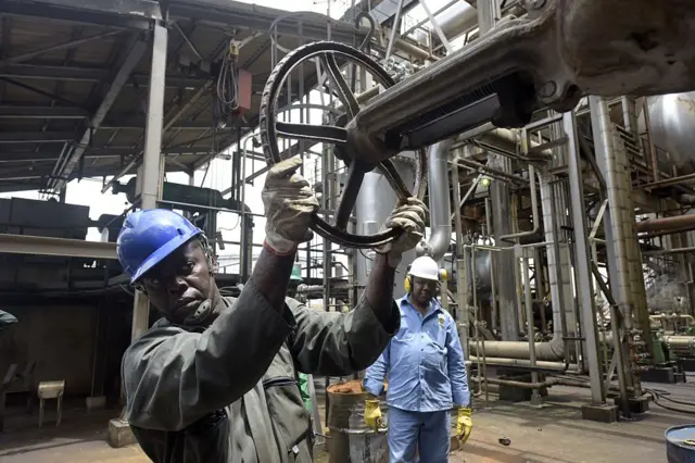 Workers at an oil refinery in Nigeria