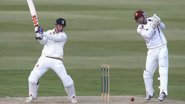 Phil Mustard of Durban cuts the ball for four runs as wicketkeeper David Murphy looks on during the second day of the LV County Championship Division One match between Northamptonshire and Durham at the County Ground on 14 April, 2014 in Northampton, England.