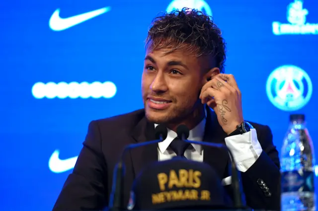 Neymar listens during a press conference