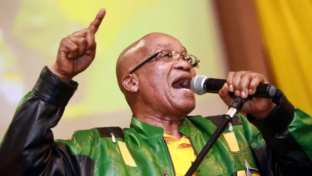 South African President and African National Congress (ANC) President Jacob Zuma leads hundreds of supporters in singing a song during a campaign event at the Inter-fellowship Church in Wentworth township, outside of Durban, on April 9, 2014, ahead of elections on May 7