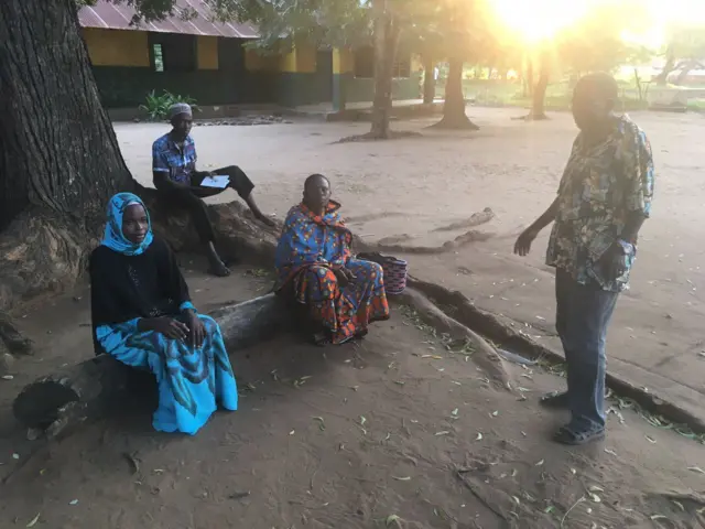 Makonde Community Chairman Thomas Nguli is seen here with other community members outside a polling station