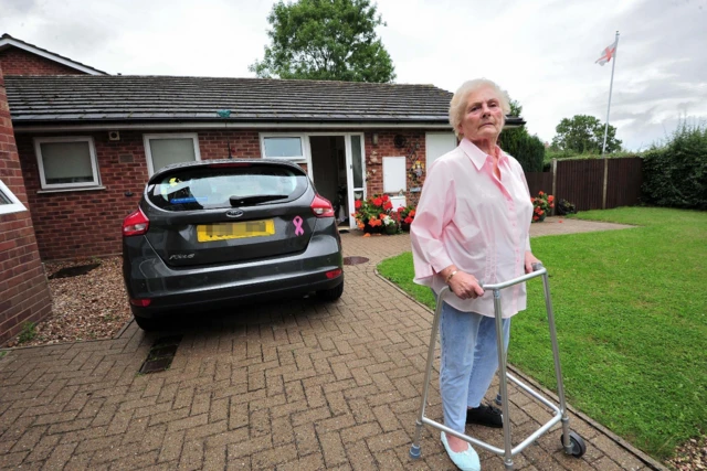 Pauline outside her home