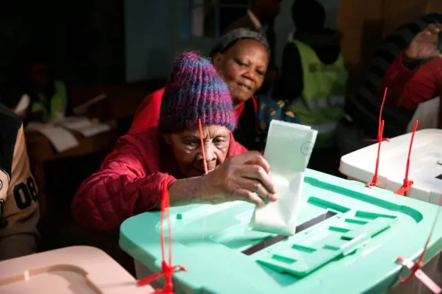 Lydia Gathoni, 102 years old, casts her vote during the presidential election at a polling station in Gatundu, Kenya