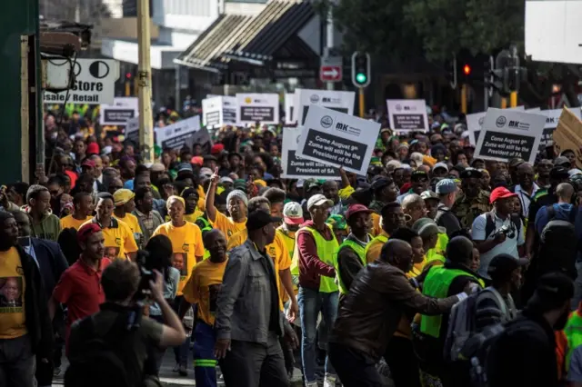 South African ruling party African National Congress (ANC) and South African President Jacob Zuma supporters march to parliament in Cape Town on August 8, 2017