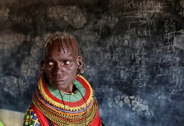 Turkana tribeswoman stands before she casts her ballot at a polling station during election in Baragoy